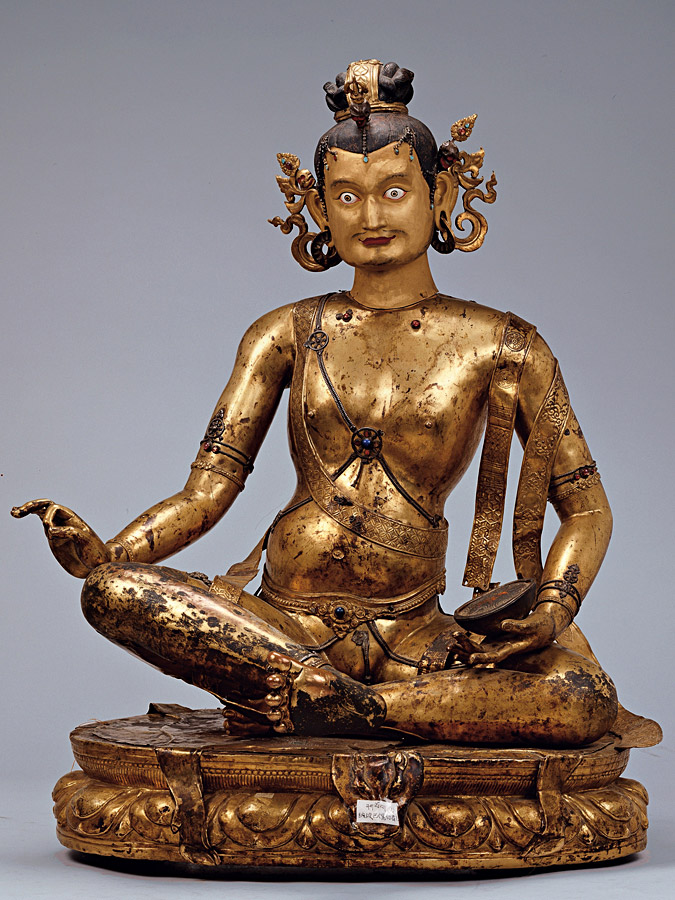 Early 16th century,  Central Tibet, Mahasiddha Kanha, gilt beaten sheet copper with gold paint, pigments, stone inlay, private collection